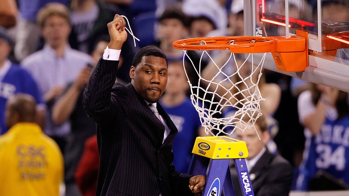 Assistant coach Nate James of the Duke Blue Devils celebrates after he cut down a piece of the net following their 61-59 win against the Butler Bulldogs during the 2010 NCAA Division I Men's Basketball National Championship game at Lucas Oil Stadium on April 5, 2010 in Indianapolis, Indiana.