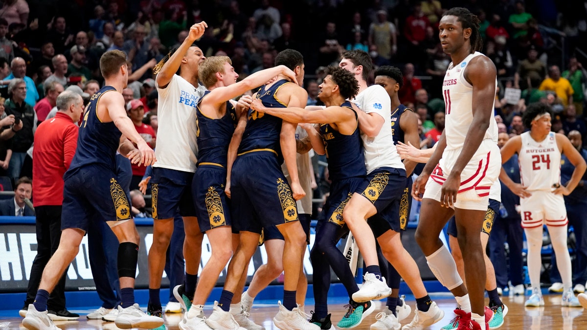 Notre Dame players celebrate after defeating Rutgers 89-87 in double overtime in a First Four game in the NCAA men's college basketball tournament, early Thursday, March 17, 2022, in Dayton, Ohio. 