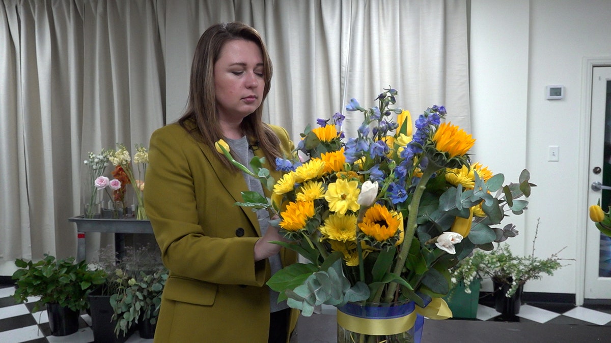 Olga Nikolayenko preparing a Ukranian-themed bouquet.