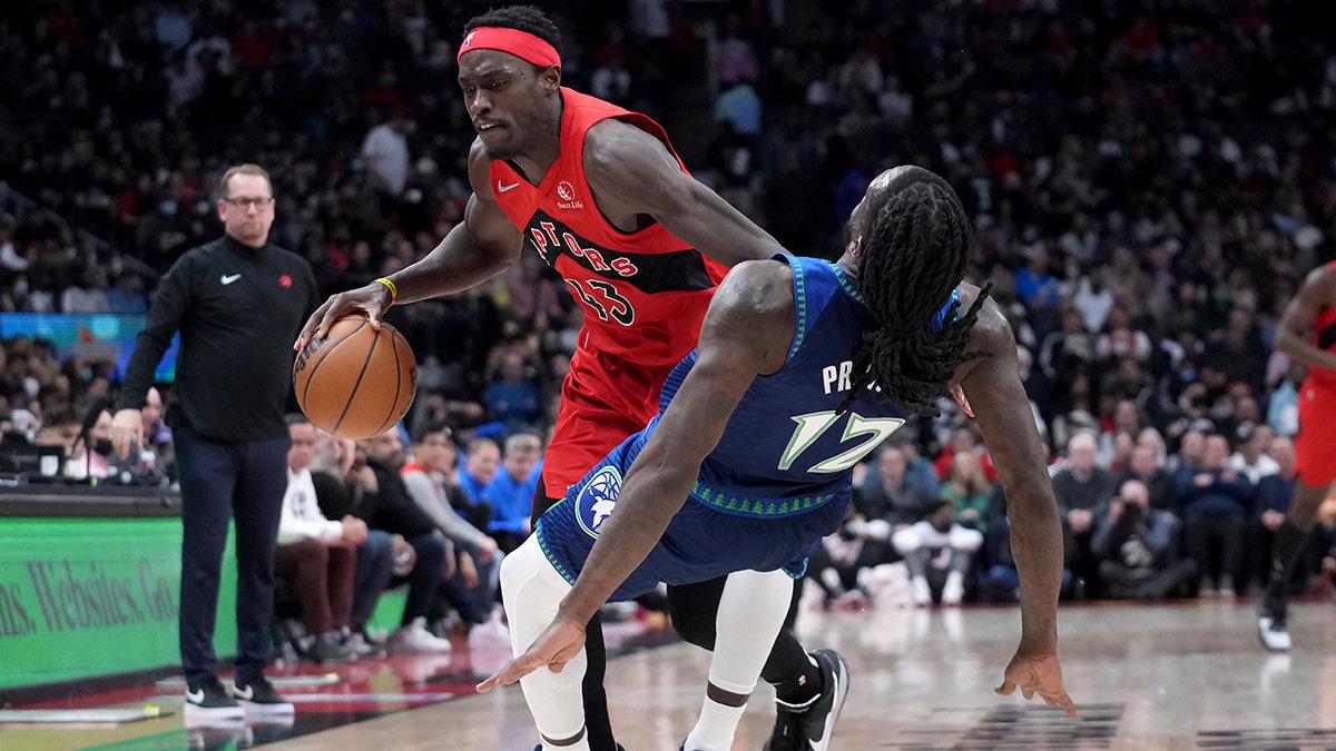 Toronto Raptors forward Pascal Siakam (43) runs into Minnesota Timberwolves forward Taurean Prince (12), sending him to the floor during the first half of an NBA basketball game Wednesday, March 30, 2022, in Toronto.