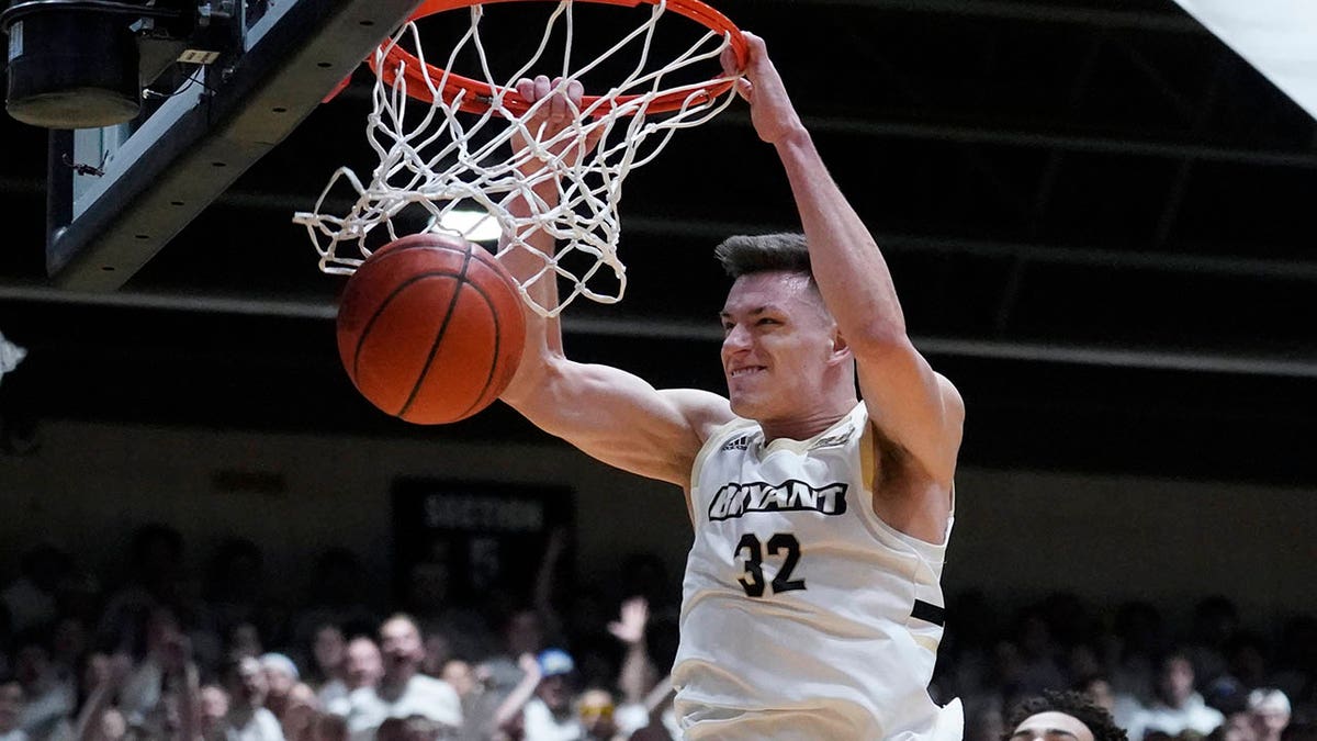 Bryant guard Peter Kiss (32) slams a dunk during the first half of the Northeast Conference men's NCAA college basketball championship game against Wagner, Tuesday, March 8, 2022, in Smithfield, R.I.