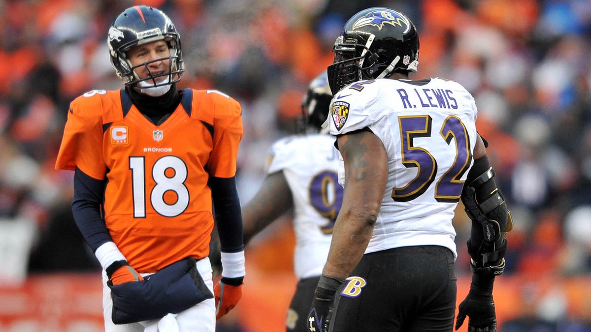 Peyton Manning (L) #18 of the Denver Broncos stnads on the field next to Ray Lewis #52 of the Baltimore Ravens during the AFC Divisional Playoff Game at Sports Authority Field at Mile High on January 12, 2013 in Denver, Colorado. 
