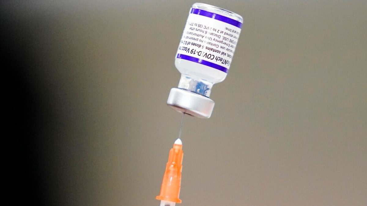 A syringe is prepared with the Pfizer COVID-19 vaccine