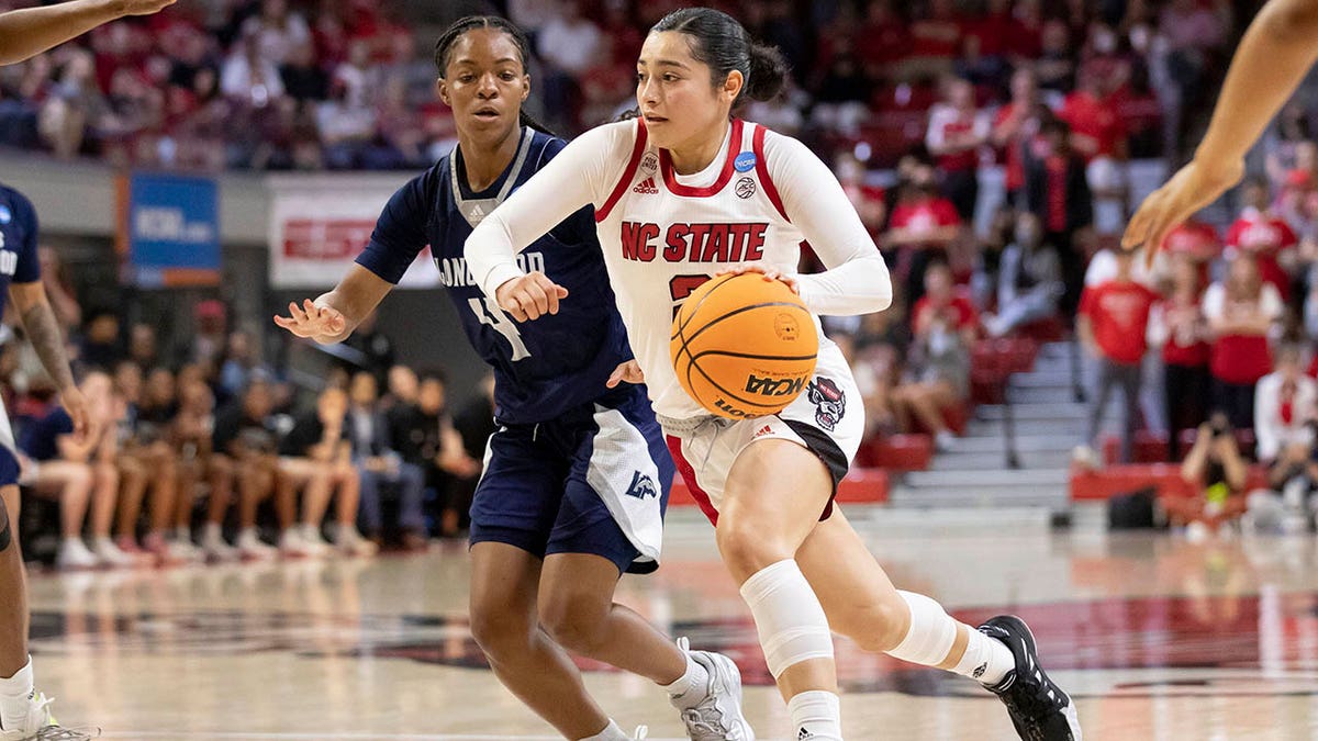 North Carolina State's Raina Perez, right, drives past Longwood's Kennedy Calhoun (4) during the second half of a college basketball game in the first round of the NCAA tournament in Raleigh, N.C., Saturday, March 19, 2022.