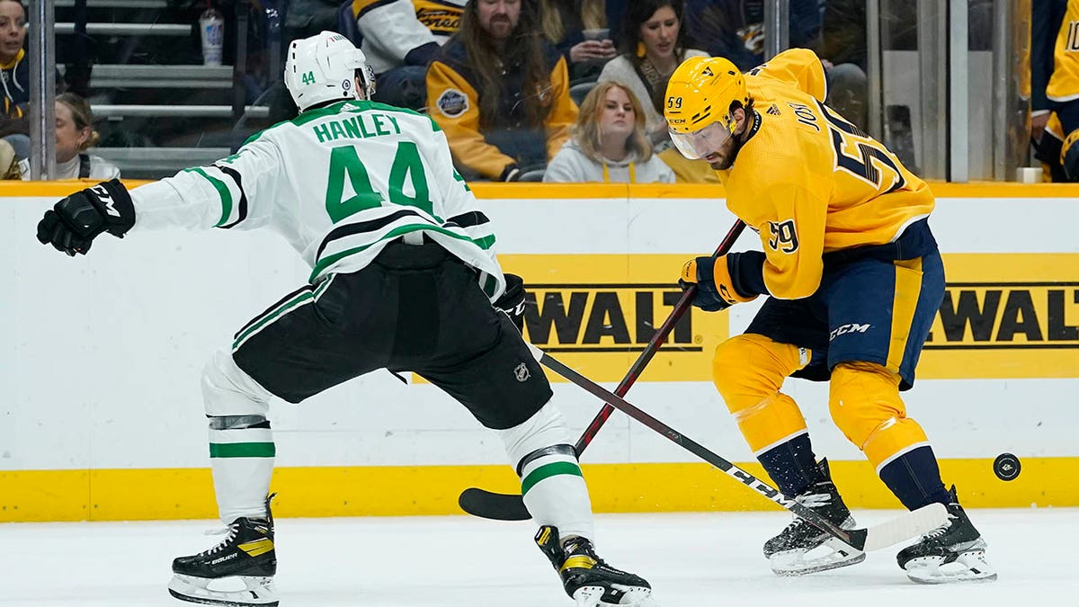 Dallas Stars' Joel Hanley (44) pokes the puck away from Nashville Predators' Roman Josi (59) in the second period of an NHL hockey game Tuesday, March 8, 2019, in Nashville, Tenn.
