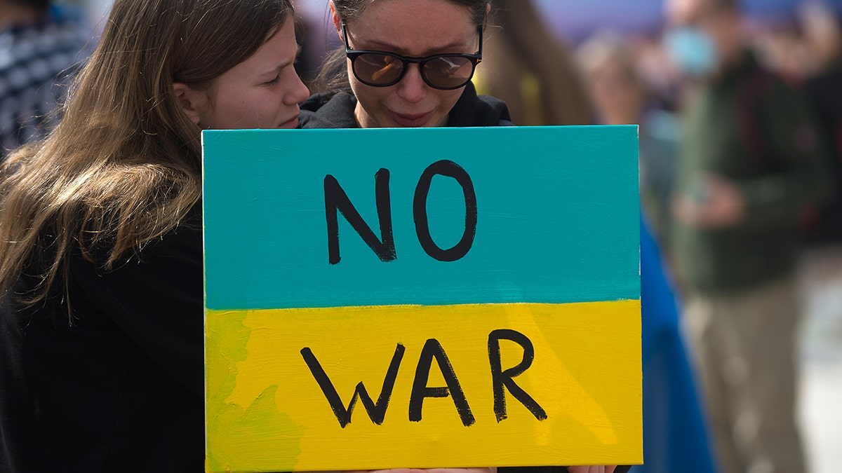A protester holds a placard during the demonstration at Plaza de la Marina square. 