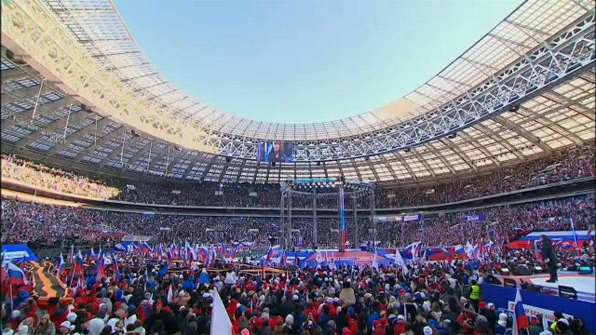 Russian President Vladimir Putin delivers a speech during a concert marking the eighth anniversary of Russia's annexation of Crimea at Luzhniki Stadium in Moscow, March 18, 2022.