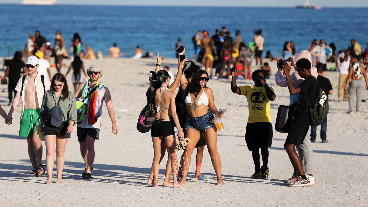 People gather during spring break in Miami Beach, Florida, on March 26, 2022.