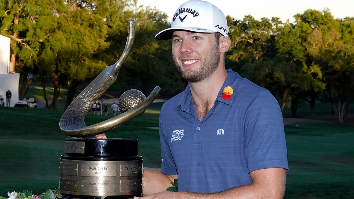 Sam Burns poses with the trophy after winning the Valspar Championship golf tournament Sunday, March 20, 2022, at Innisbrook in Palm Harbor, Fla.