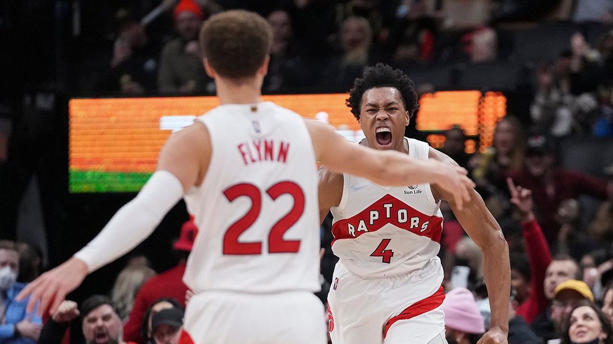 Toronto Raptors forward Scottie Barnes (4) celebrates with guard Malachi Flynn (22) during the second half of the team's NBA basketball game against the Toronto Raptors on Tuesday, March 1, 2022, in Toronto.