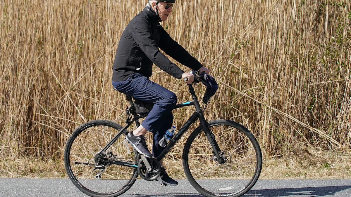 President Joe Biden rides a bicycle in Gordon's Pond State Park in Rehoboth Beach, Del., Sunday, March 20, 2022. (AP Photo/Carolyn Kaster)