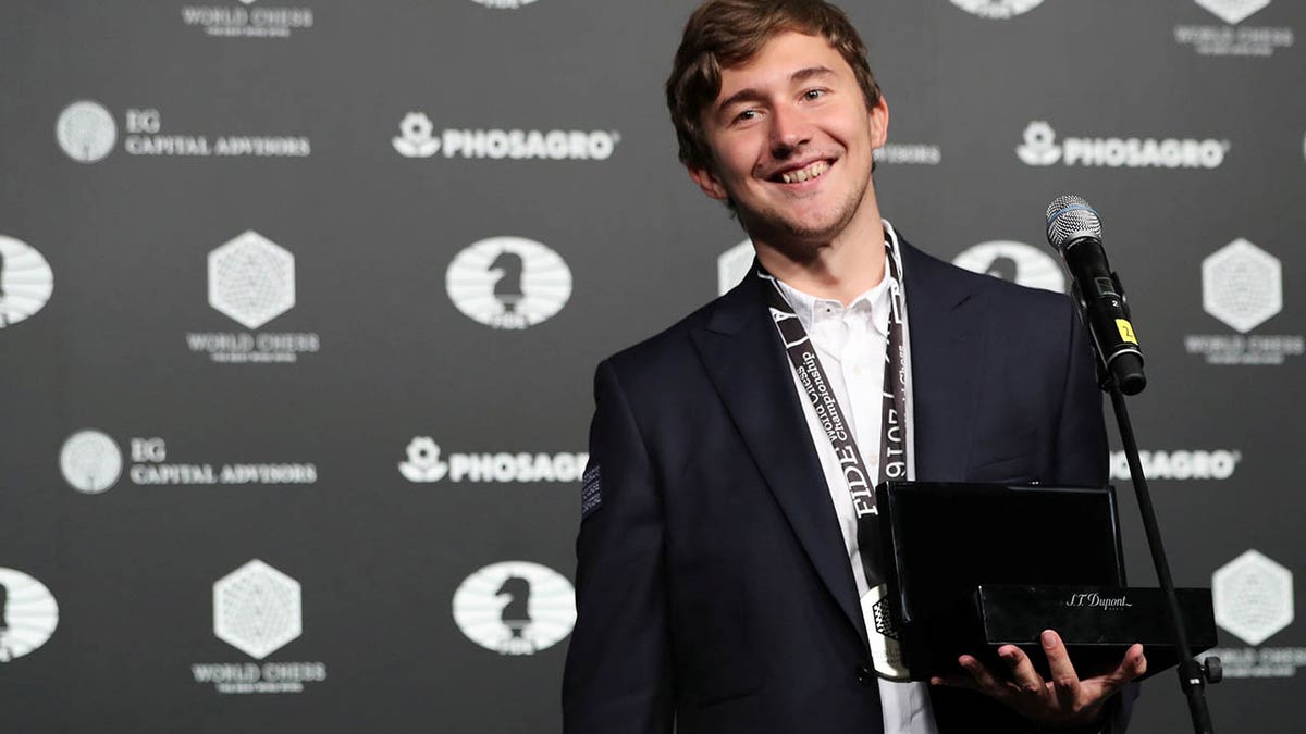 Sergey Karjakin of Russia smiles after being cheered by fans at an award ceremony after losing to Magnus Carlsen of Norway at the 2016 World Chess Championship match in New York, Nov. 30, 2016.