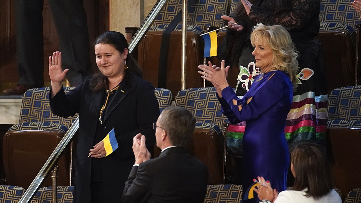 Oksana Markarova, ambassador of Ukraine to the United States, left, gestures while being introduced next to U.S. First Lady Jill Biden, right, during a State of the Union address by U.S. President Joe Biden at the U.S. Capitol in Washington, D.C., U.S., on Tuesday, March 1, 2022. Biden's first State of the Union address comes against the backdrop of Russia's invasion of Ukraine and the subsequent sanctions placed on Russia by the U.S. and its allies. Photographer: Al Drago/Bloomberg via Getty Images