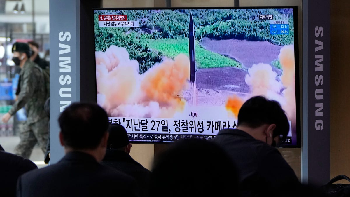 People watch a TV showing a file image of North Korea's missile launch during a news program at the Seoul Railway Station in Seoul, South Korea, Saturday, March 5, 2022. (Associated Press)
