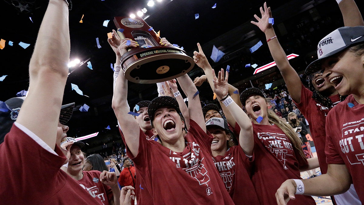 Stanford players celebrate with the regional trophy after they beat Texas 59-50 in a college basketball game in the Elite 8 round of the NCAA tournament, Sunday, March 27, 2022, in Spokane, Wash. Stanford won 59-50.