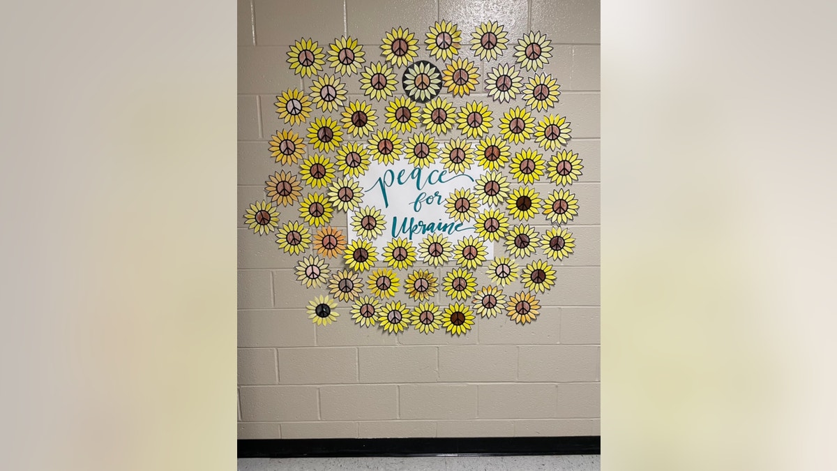 "Peace for Ukraine," reads this note — surrounded by sunflowers — on one of the hallways of the school where Miss Lana works as head custodian.