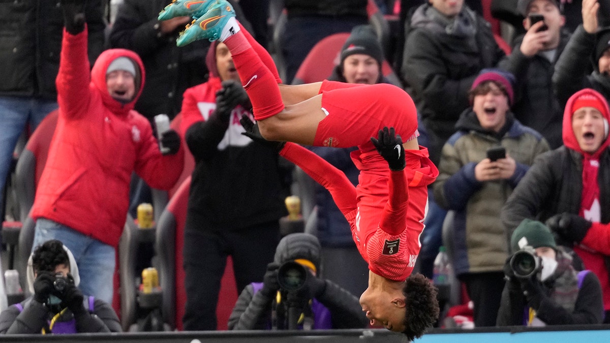 Canada's Tajon Buchanan does a backflip after scoring against Jamaica during first-half CONCACAF World Cup soccer qualifying action in Toronto, Sunday, March 27, 2022.