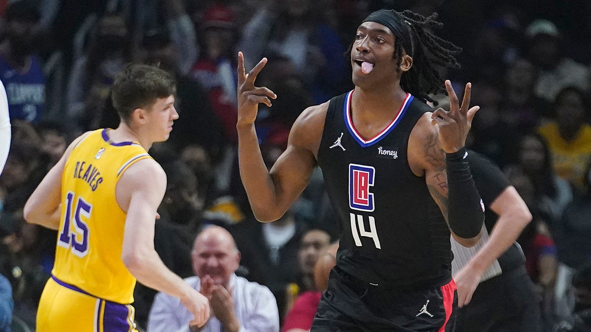 Los Angeles Clippers guard Terance Mann (14) reacts after making a 3-point basket during the first half of the team's NBA basketball game against the Los Angeles Lakers on Thursday, March 3, 2022, in Los Angeles.