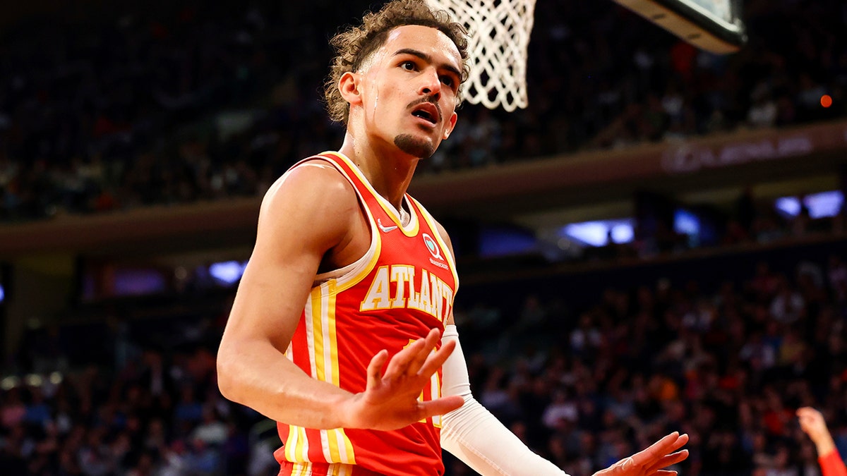 Atlanta Hawks guard Trae Young (11) motions to the crowd during the first half of an NBA basketball game against the New York Knicks, Tuesday, March 22, 2022, in New York.