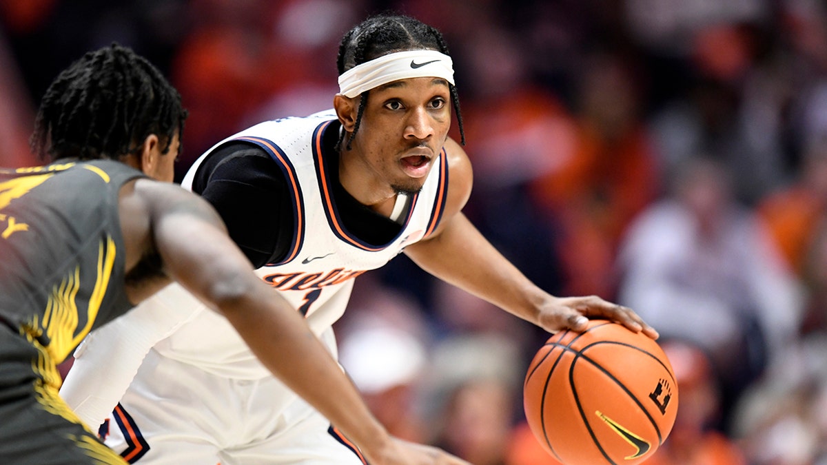 Illinois' Trent Frazier eyes a passing outlet during the first half of an NCAA college basketball game against Iowa, Sunday, March 6, 2022, in Champaign, Ill.