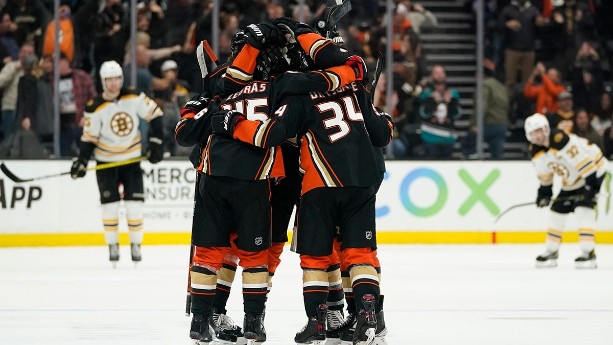 Anaheim Ducks center Trevor Zegras (46) celebrates with teammates after scoring a goal during the third period of an NHL hockey game against the Boston Bruins in Anaheim, Calif., Tuesday, March 1, 2022. The Ducks won 4-3.