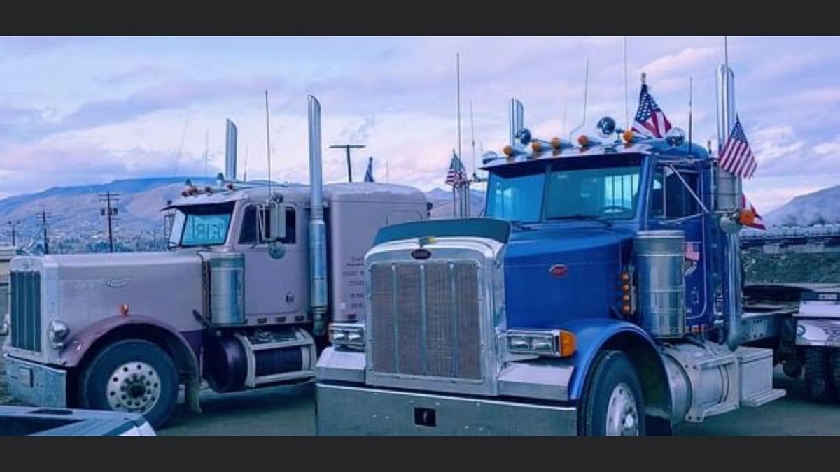 Trucks park side-by-side taking part in a nationwide convoy from California to Washington D.C. Thousands of truckers are convoying from various parts of the country to protest COVID-19 mandates and other issues. 