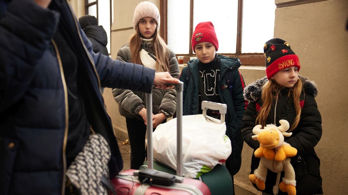 Ukrainian family at train station to escape war