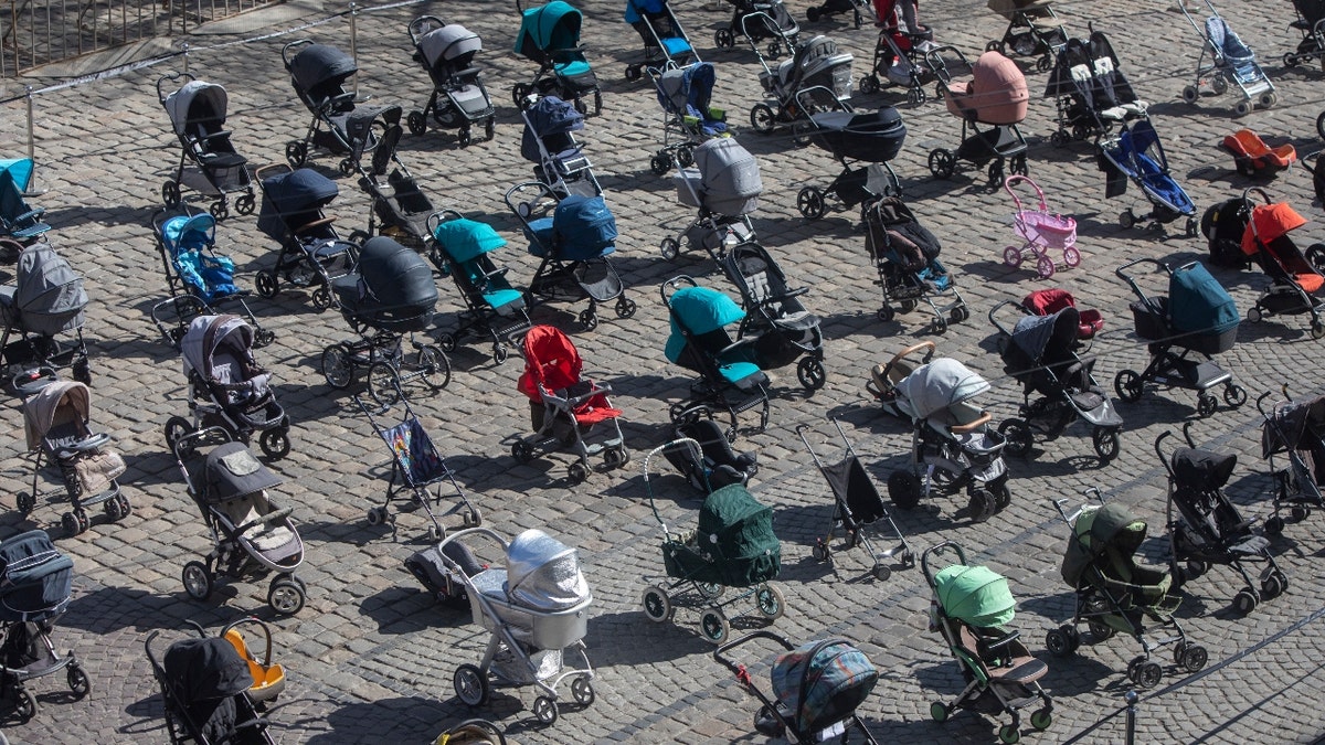 On 17 March 2022 in Lviv, western Ukraine, empty strollers were placed in neat rows at the central square, to symbolize children killed in the ongoing war. (Aleksey Filippov/ UNICEF)