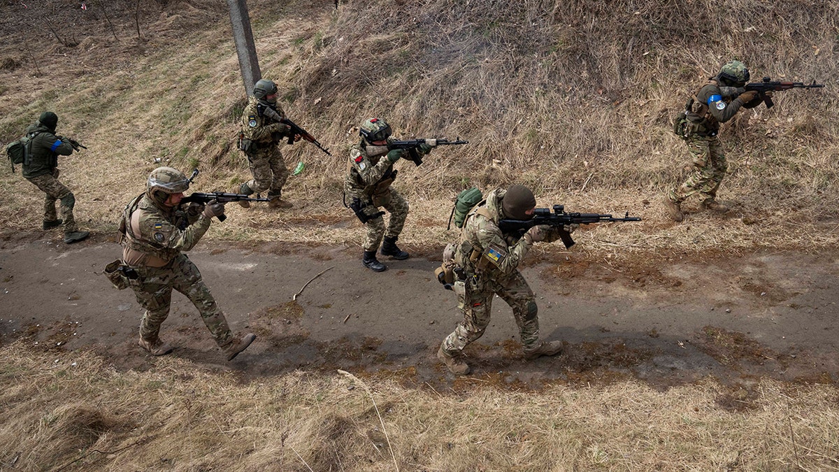 Ukrainian soldiers of the 103rd Separate Brigade of the Territorial Defense of the Armed Forces, fire their weapons, during a training exercise, at an undisclosed location, near Lviv, western Ukraine, Tuesday, March 29, 2022. (AP Photo/Nariman El-Mofty)