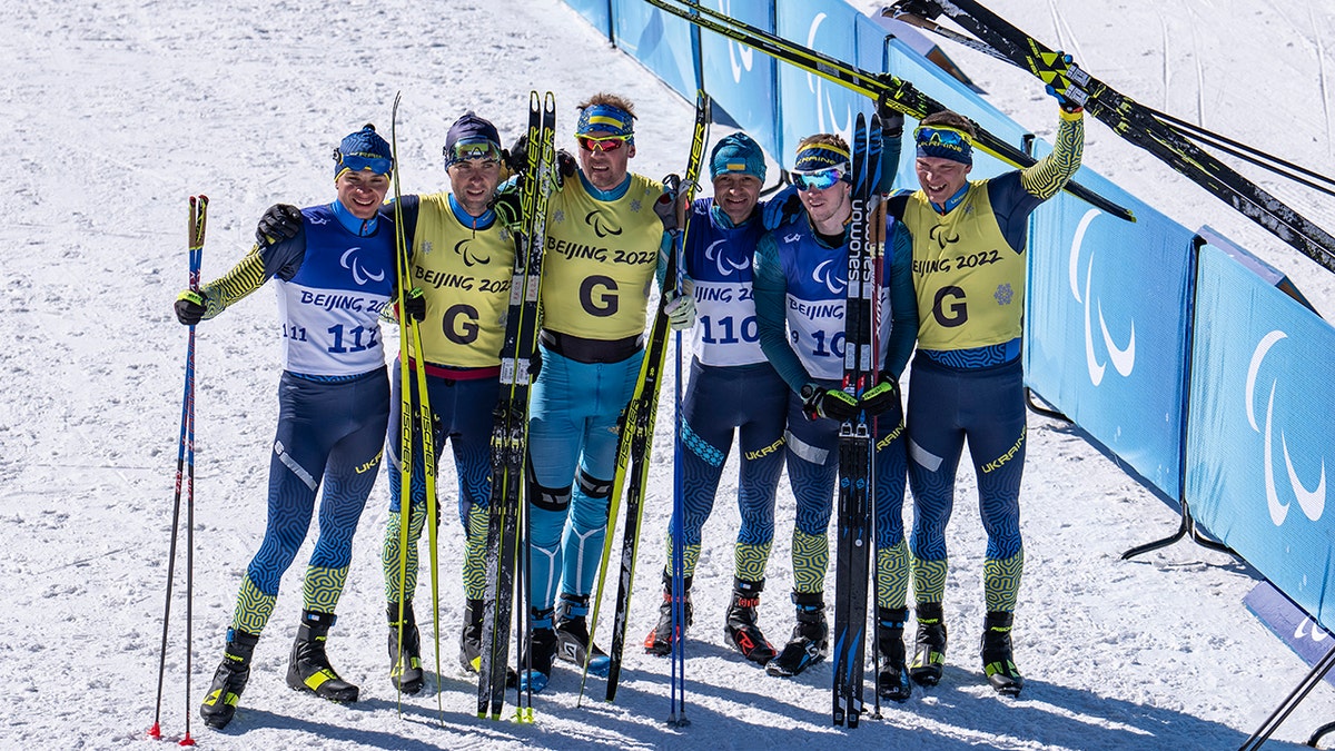 Left to right, Silver medalist Oleksandr Kazik of the Ukraine, alongside his guide Serhii Kucheriavyi, gold medalist Vitalii Lukianenko of the Ukraine, alongside his guide Boys Babar (left of center), and bronze medalist Dmytro Suiarko of the Ukraine, alongside his guide Oleksandr Nikonovych, pose together for a group photo after their domination in the Men's Sprint Vision Impaired Para Biathlon at the Zhangjiakou National Biathlon Centre. Beijing 2022 Winter Paralympic Games, Zhangjiakou, China, Saturday, March 5, 2022.