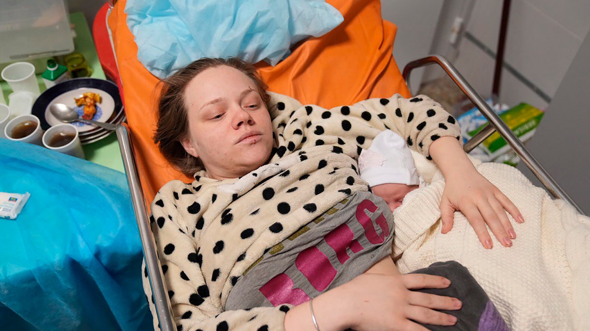 Mariana Vishegirskaya lies in a hospital bed after giving birth to her daughter Veronika, in Mariupol, Ukraine, Friday, March 11, 2022.