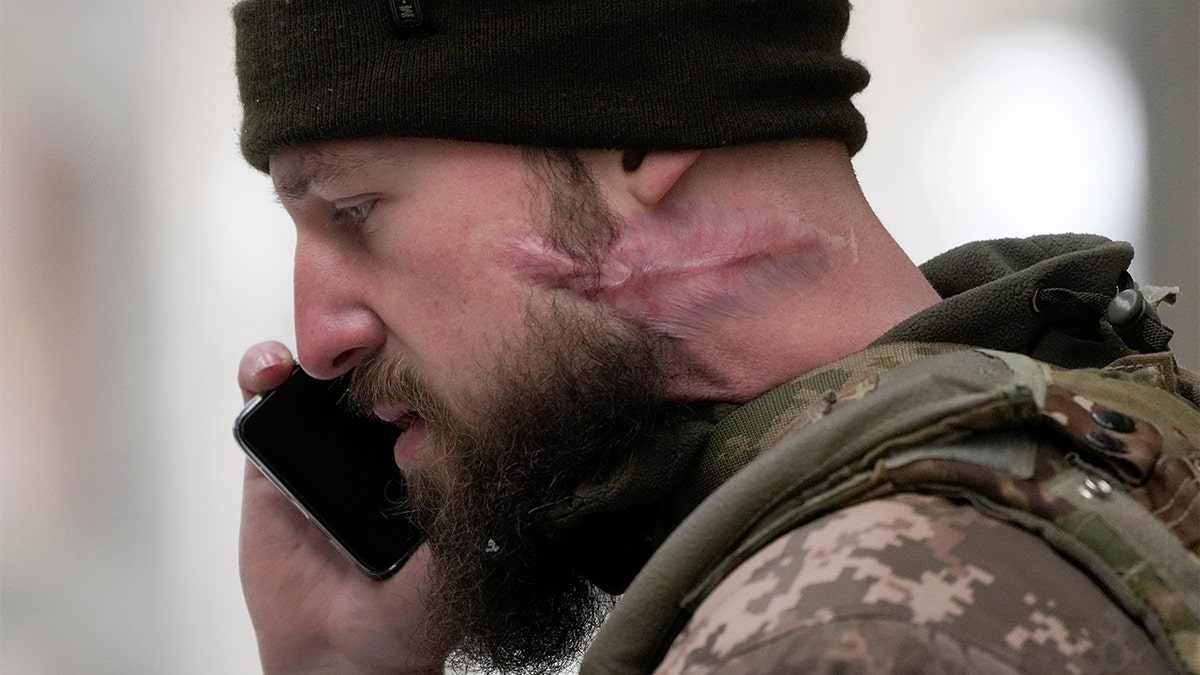 A Belarusian volunteer speaks by phone as he receives military training at the Belarusian Company base in Kyiv, Ukraine, Tuesday, March 8, 2022. Hundreds of Belarus' emigrants and citizens have arrived in Ukraine to help the Ukrainian army fight against Russian invaders. (AP Photo/Efrem Lukatsky)