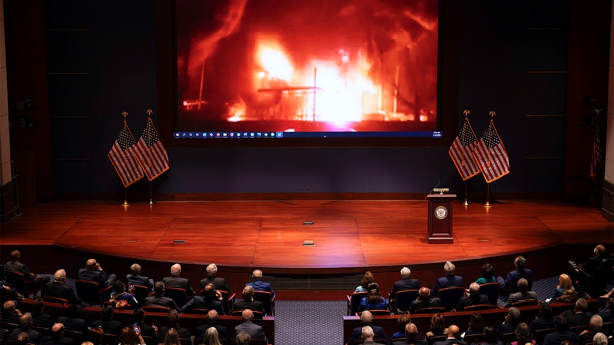 Footage of the war in Ukraine is displayed as Ukrainian President Volodymyr Zelenskyy speaks to the U.S. Congress by video to plead for support as his country is besieged by Russian forces, at the Capitol in Washington, Wednesday, March 16, 2022. (AP Photo/J. Scott Applewhite, Pool)