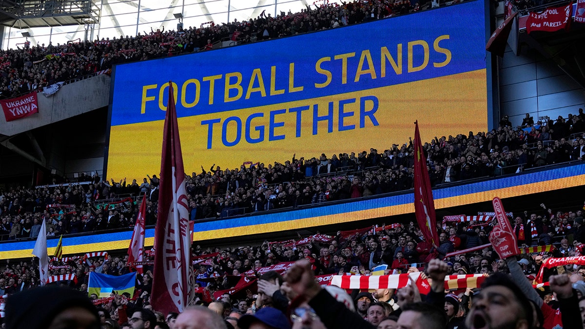 A video screen displays the Ukrainian flag, during the English League Cup final soccer match between Chelsea and Liverpool at Wembley stadium in London, Sunday, Feb. 27, 2022.