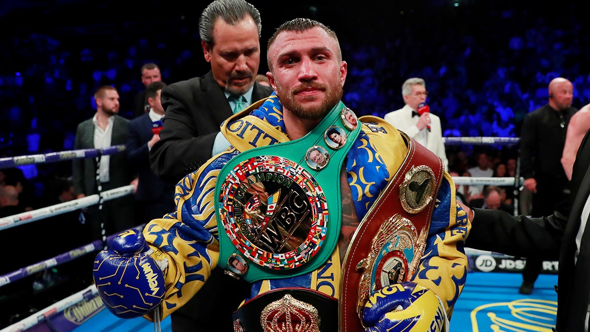 Vasyl Lomachenko poses as he celebrates winning the fight.