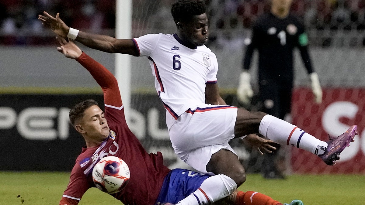 Costa Rica's Brandon Aguilera, below, and United States' Yunus Musah battle for the ball during a qualifying soccer match for the FIFA World Cup Qatar 2022 in San Jose, Costa Rica, Wednesday, March 30, 2022.