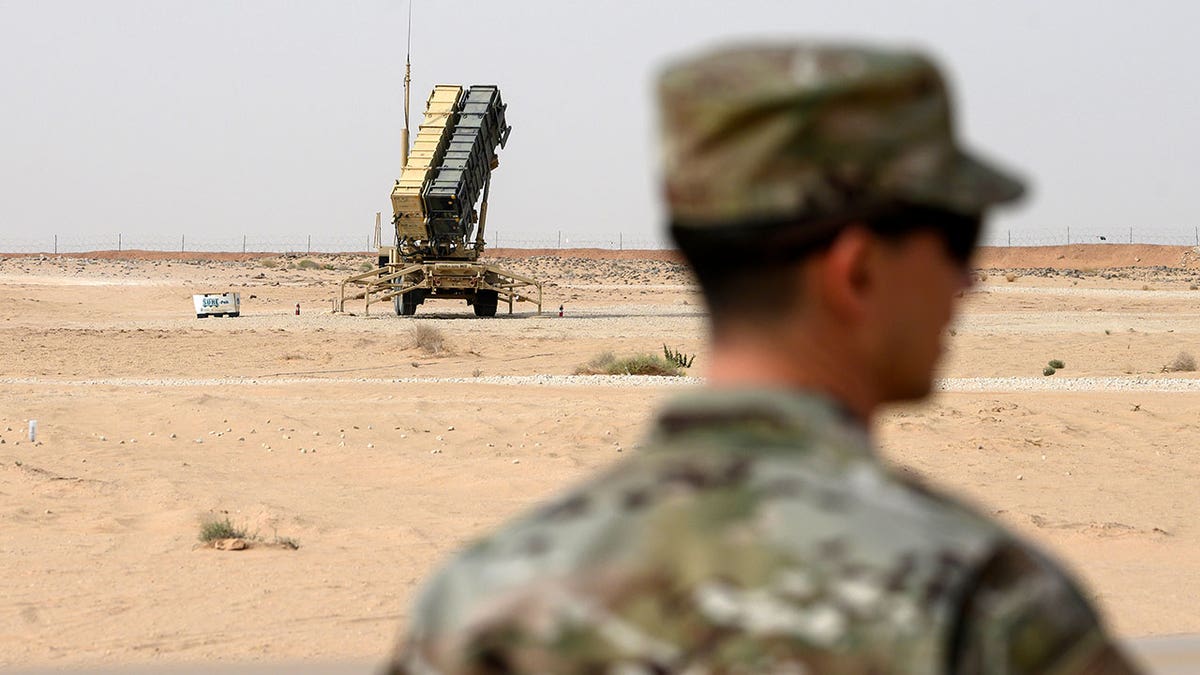 A member of the U.S. Air Force stands near a Patriot missile battery at the Prince Sultan air base in al-Kharj, central Saudi Arabia, on Feb. 20, 2020. 