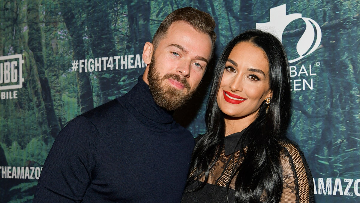 Artem Chigvintsev (L) and Nikki Bella are engaged and share one son. 