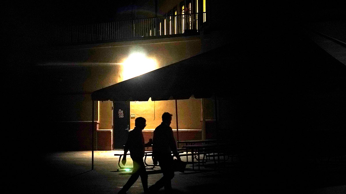 Representatives from Major League Baseball walk to labor negotiations with the players' association, Monday, Feb. 28, 2022, at Roger Dean Stadium in Jupiter, Fla.
