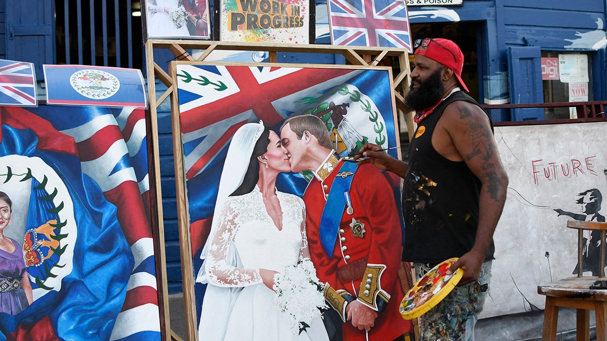 Artist Alex Sanker, 51, paints a picture of Britain's Prince William and his wife Catherine, in a street of Belize City, on March 18, 2022, the day ahead of their visit. 