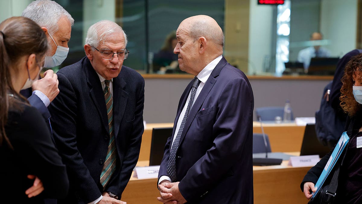 European foreign policy chief Josep Borrell, left, speaks with French Foreign Minister Jean-Yves Le Drian during a meeting of the EU foreign ministers at the Europa building in Brussels, Monday, Mar. 21, 2022. 