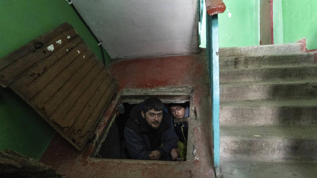 People hide in an improvised bomb shelter in Mariupol, Ukraine, March 12, 2022.