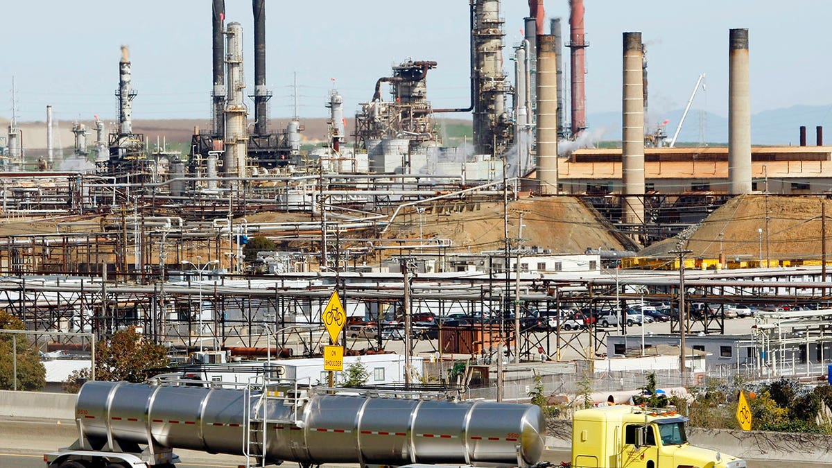 A tanker truck passes the Chevron oil refinery in Richmond, California, on March 9, 2010.