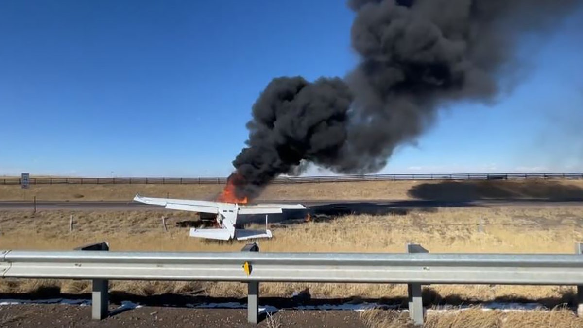 A pilot and passenger survived a fiery plane crash on a Colorado highway near an airport on Tuesday, fire officials said.