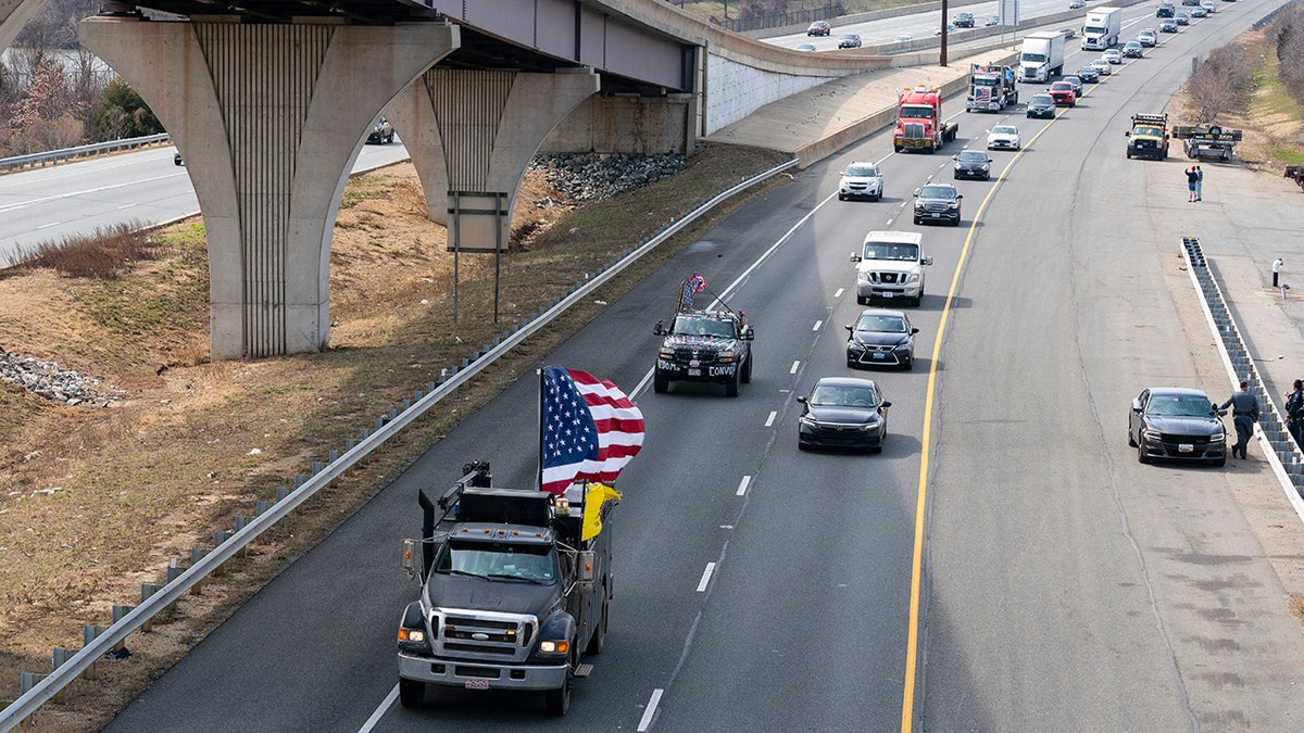 A convoy of trucks and other vehicles travels the I-495 Capital Beltway near the Woodrow Wilson Bridge, to protest mandates and other issues, Sunday, March, 6, 2022, in Fort Washington, Md. (AP Photo/Alex Brandon)