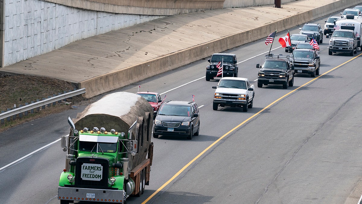 A convoy of trucks and other vehicles travels the I-495 Capital Beltway near the Woodrow Wilson Bridge, to protest mandates and other issues, Sunday, March, 6, 2022, in Fort Washington, Maryland. (AP Photo/Alex Brandon)