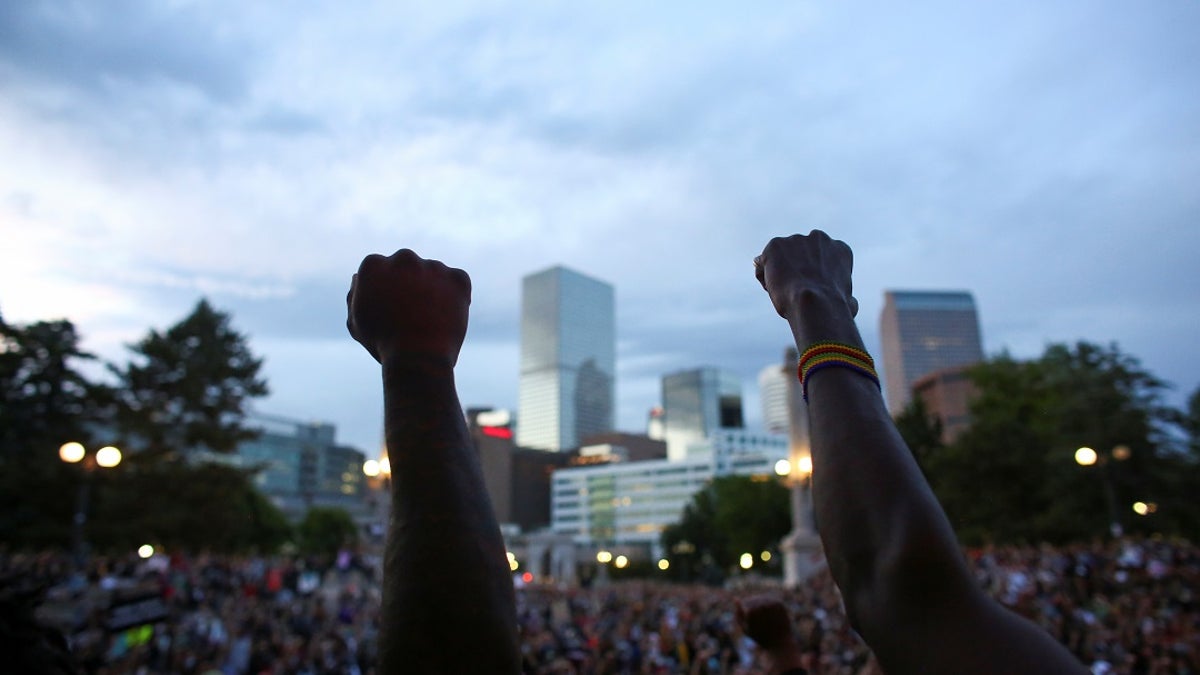 Demonstrators raise their fists at a protest against racial inequality in the aftermath of the death in Minneapolis police custody of George Floyd, in Civic Center Park, Denver, Colorado, U.S., June 3, 2020.