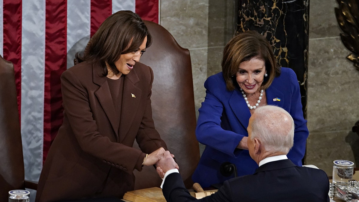 President Biden greets Vice President Kamala Harris, left, and House Speaker Nancy Pelosi after delivering his State of the Union address at the U.S. Capitol in Washington, D.C., March 1, 2022. Harris wore an all-brown suit during the president's speech. 