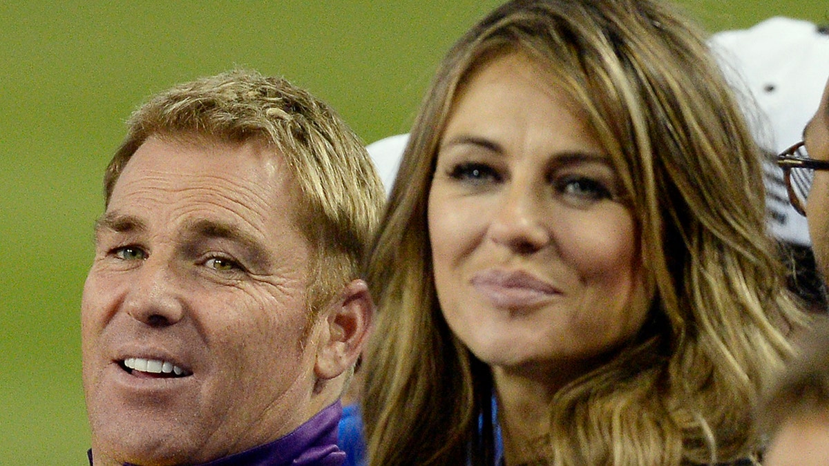 Actress Elizabeth Hurley, right, poses with Shane's Warriors Shane Warne the during the final game of a three-match three city US tour of Twenty20 series of Cricket All-Stars Series game against Sachin's Blasters at Dodger Stadium Nov. 14, 2015, in Los Angeles.?