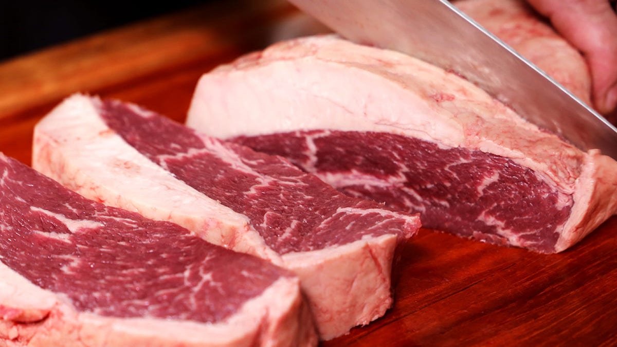Raw steak getting cut